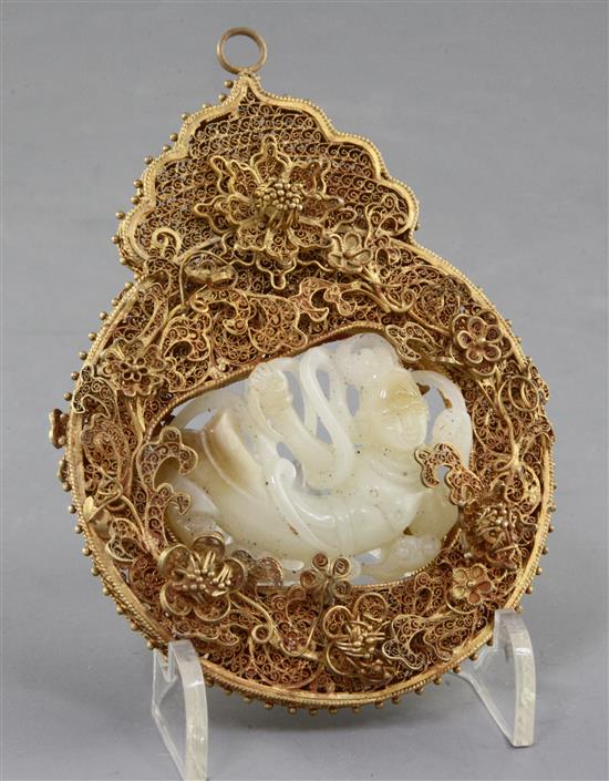 A Chinese pale celadon and russet jade gilt filigree mounted pendant, height 12cm